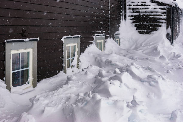 Storm. Heavy snowfall. House littered with snow. Disaster