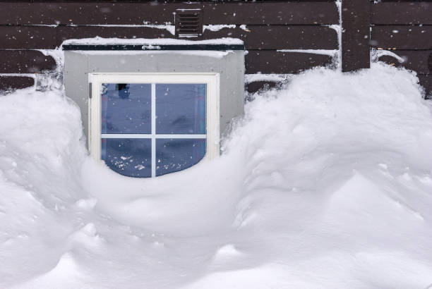 istock Storm. Heavy snowfall. House littered with snow. Disaster 1203940666