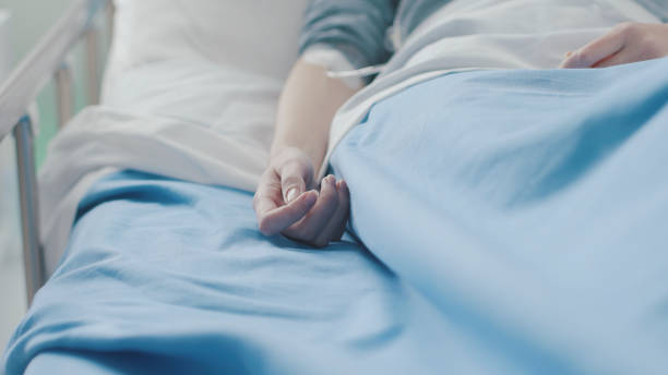 istock Patient in a hospital bed with IV drip 1203942804