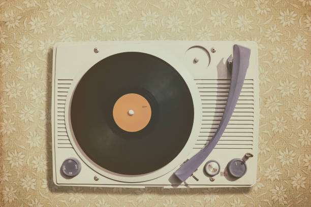 istock Old record player on top of flower wallpaper 1203943861