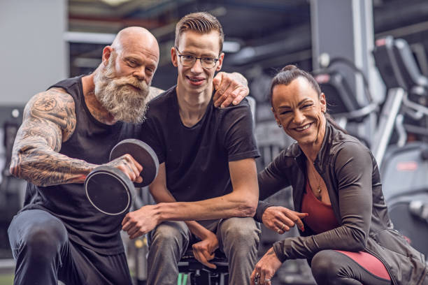 istock Disabled young male athlete during Gym Workout with his coaching team 1203943980