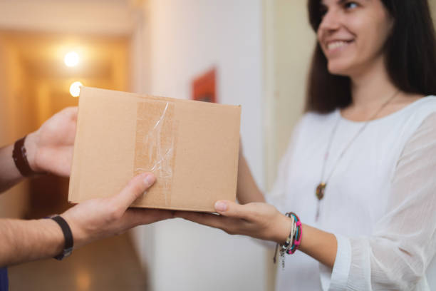 istock Woman receiving a package 1203945325