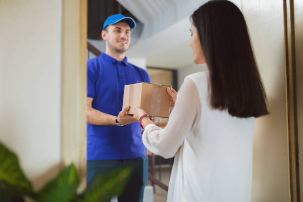 istock Woman receiving a package 1203945356