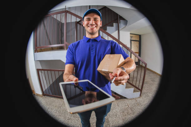 istock Postman at the door 1203945440