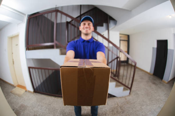 Postman at the door Postman at the door viewed through a spy hole peep hole stock pictures, royalty-free photos & images