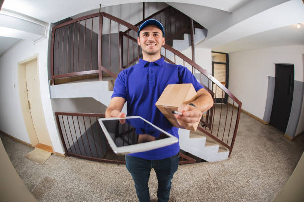 istock Postman at the door 1203945484