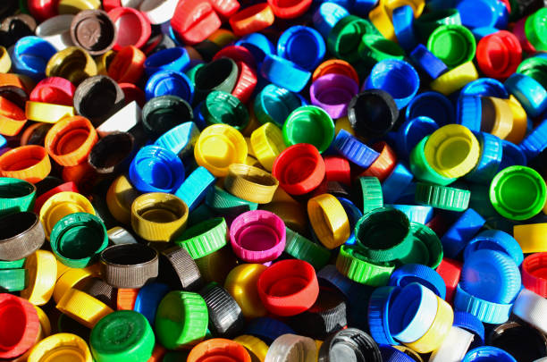 istock Plastic bottle caps background. Cap material is recyclable.Remove lids from plastic bottles before recycling them. 1203946635
