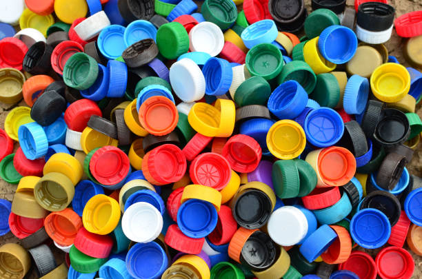 istock Plastic bottle caps background. Cap material is recyclable.Remove lids from plastic bottles before recycling them. 1203946646