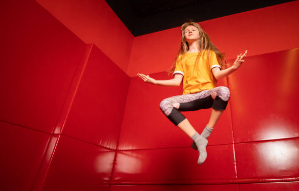 istock Child girl jumping on trampoline and having fun 1203946653