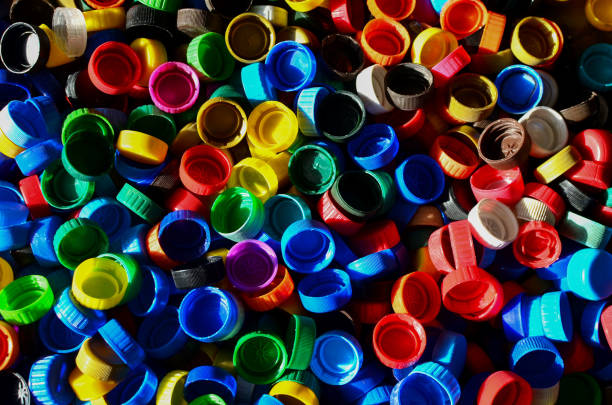 istock Plastic bottle caps background. Cap material is recyclable.Remove lids from plastic bottles before recycling them 1203947364