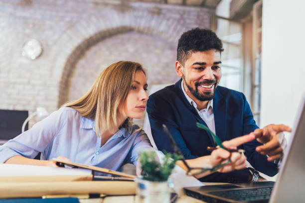 istock Business people working together in modern office. 1203948637