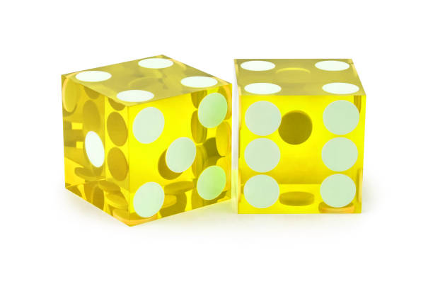 istock Two yellow professional game dice closeup isolated on a white background / four and four with a light shadow. 1203950193