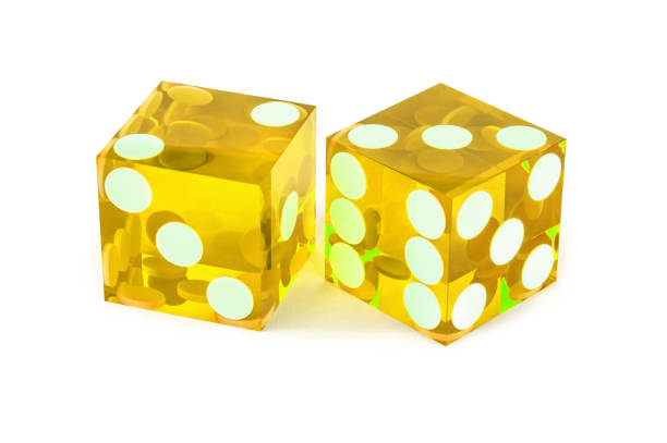 istock Two yellow professional game dice closeup isolated on a white background / two and three with a light shadow. 1203950204