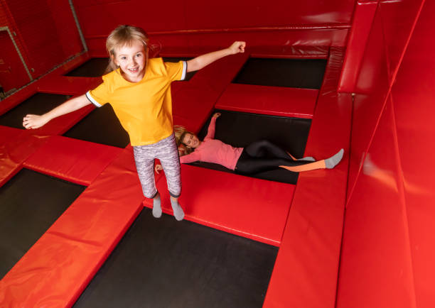 istock Happy family having fun while jumping on trampoline 1203953130