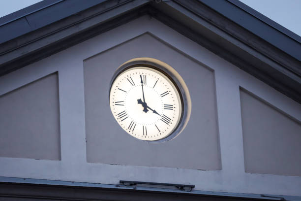 istock Old clock on house wall showing 16 PM 1203955057