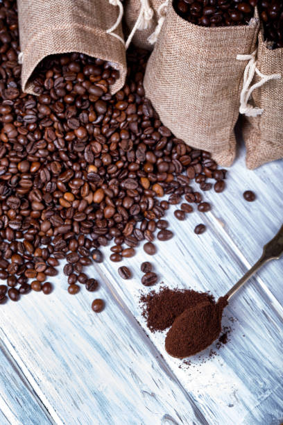 istock Ground coffee in spoon with coffee beans. 1203955120