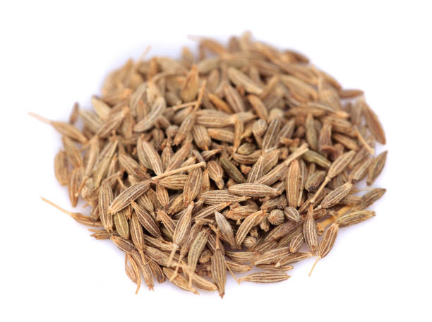 istock Heap of dried cumin seeds on a white isolated background 1203956365