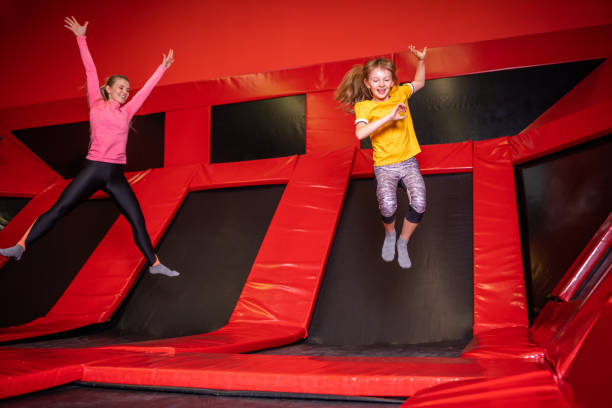 istock Happy mom and her daughter jumping on trampoline in fly park 1203956576