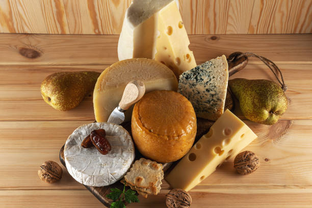 istock Assortment of different cheese types on wooden table. Cheese background. Top view. 1203958385