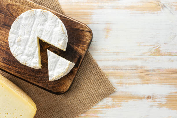 istock Assortment of different cheese types on white wooden table. Cheese background. 1203958569