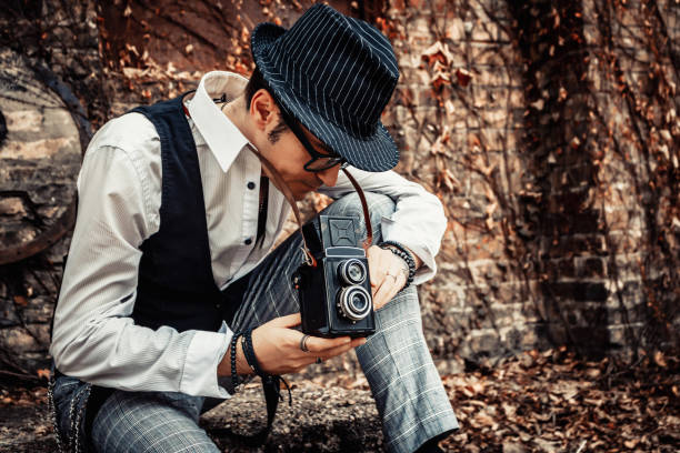 istock Photographer looking through visor of medium format camera. 1203960097