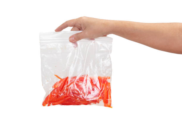 Holding Slices of red pepper in plastic bag