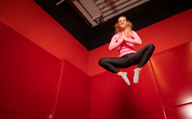istock Woman jumping on trampoline and having fun 1203960427