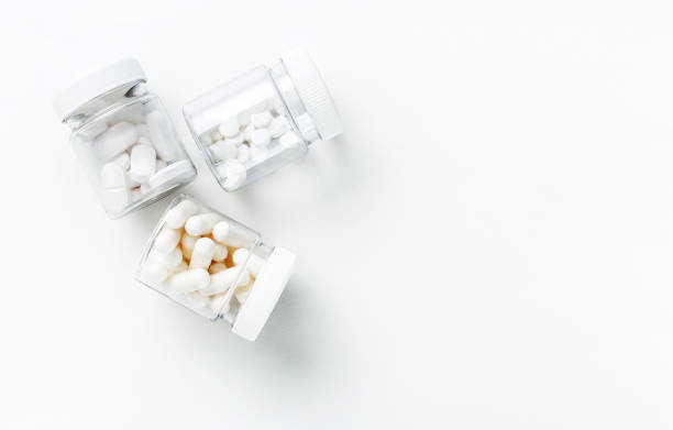 istock Three packages with various white pills and capcules on a white background. Health concept. 1203960469