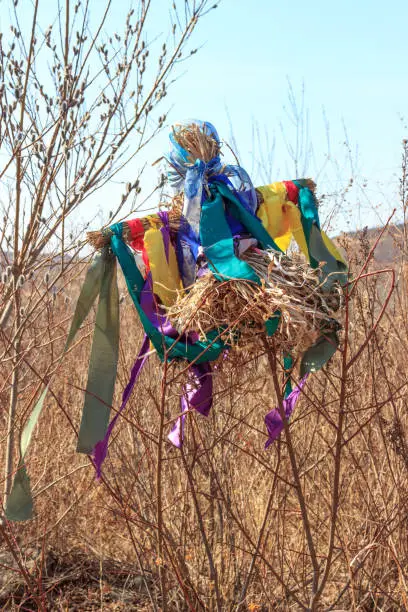 Photo of A traditional Russian folk scarecrow made on Maslenitsa (Shrovetide) celebration for burning on a fire.