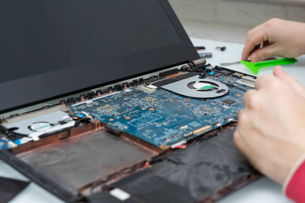 istock the master opens the laptop. computer repair 1203961572