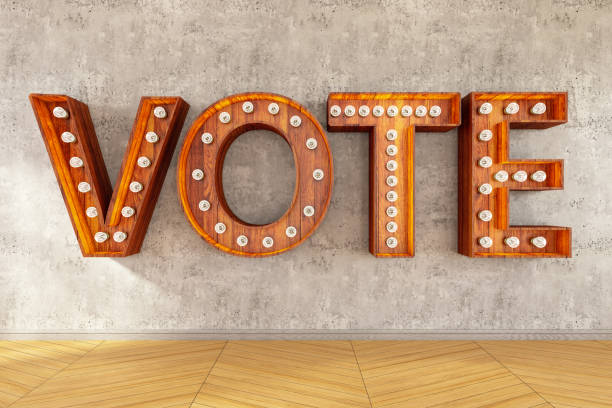 istock Vote Sign with Light Bulbs on Concrete Wall 1203961893