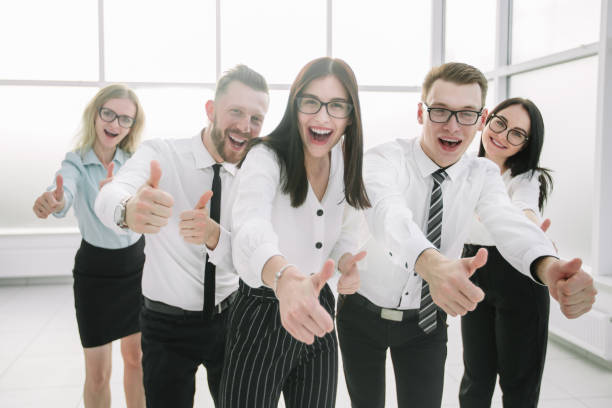 istock fun business team showing their thumbs up. 1203962124