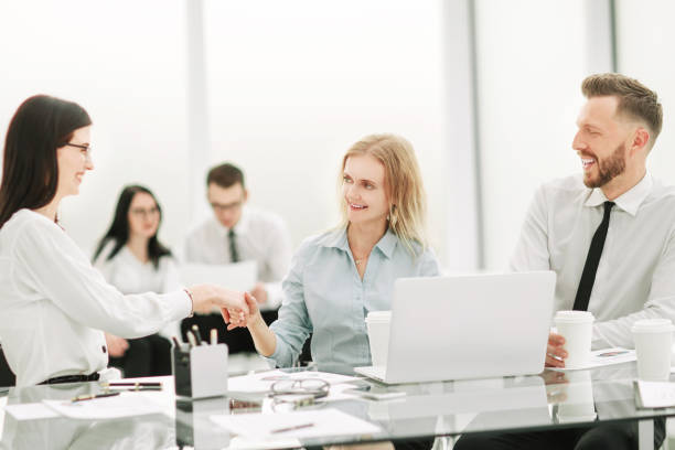 istock Manager shaking hands with client at office meeting 1203962177