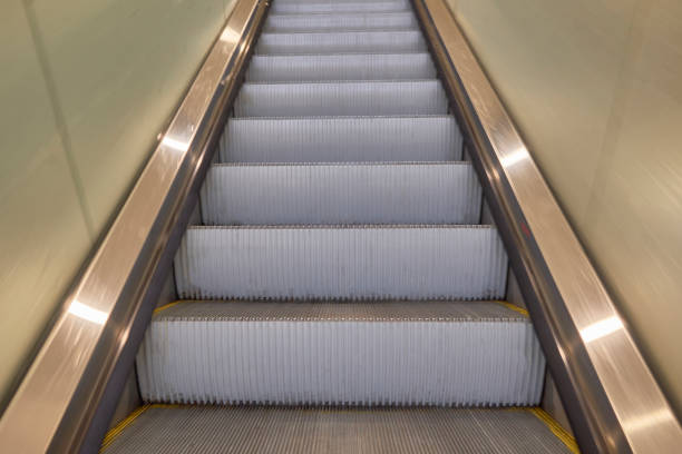 istock Stairs of escalator. Pedestrian and disabled people facilities 1203964154