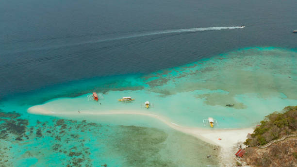 istock Small torpic island with a white sandy beach, top view 1203965035