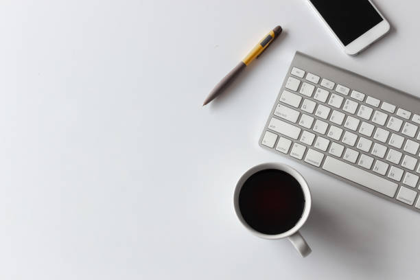 istock top view office table desk. coffee cup, smartphone, pen, keyboard and other office equipment on white background 1203965086