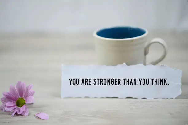 Photo of You are stronger than you think, a paper note with morning coffee.