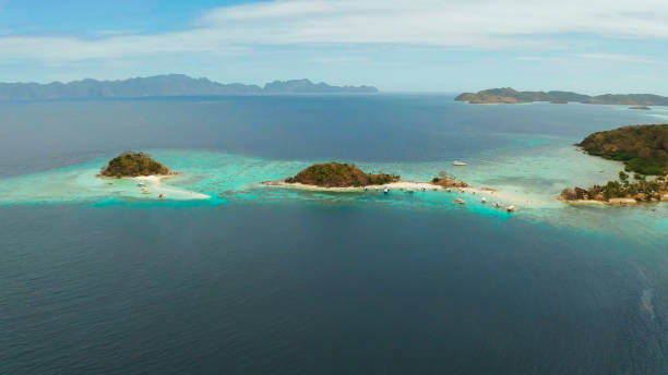 istock Small torpic island with a white sandy beach, top view 1203965281