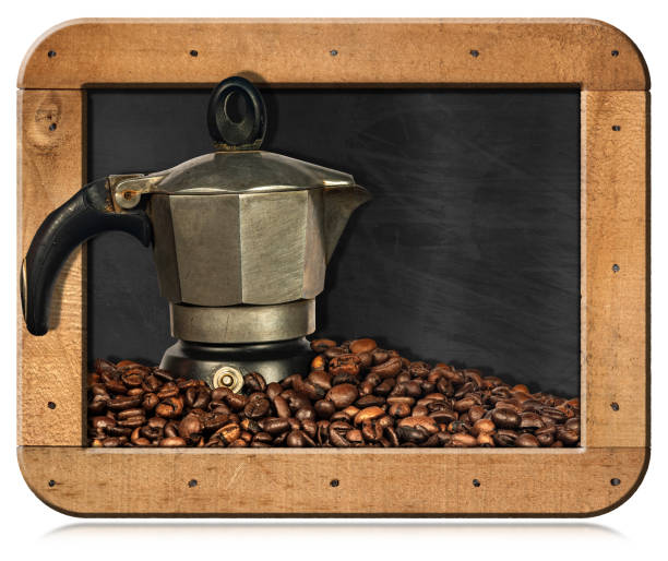 Old Italian coffee maker (moka pot, side view) on a stack of roasted coffee beans, in a blackboard with copy space, isolated on white background