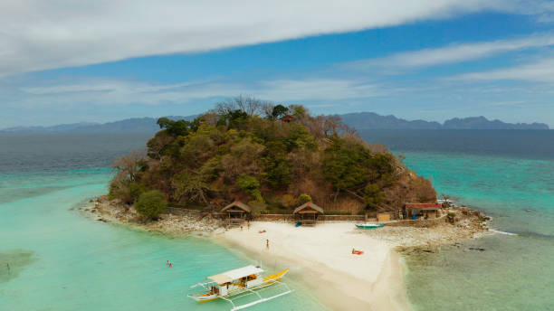 istock Small torpic island with a white sandy beach, top view 1203965357