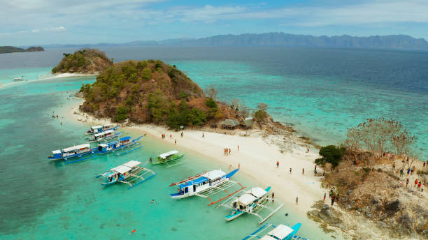 istock Small torpic island with a white sandy beach, top view 1203965477
