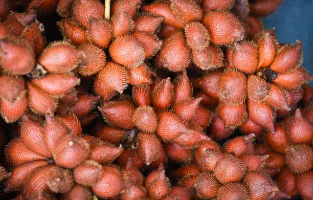 Photo of Salak Palm texture background or snake fruit for sale in the fruit market - Salacca zalacca