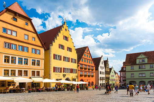 Rothenburg Ob Der Tauber, Germany - August 17, 2018: Market Place of the historic old town Rothenburg ob der Tauber with Rathaus buildings in summer. Rothenburg ob der Tauber is a famous town in Bavaria, west of Munich, Germany. This old bavarian city is situated on the Romantic Road. Rothenburg ob der Tauber is a UNESCO World Heritage site.