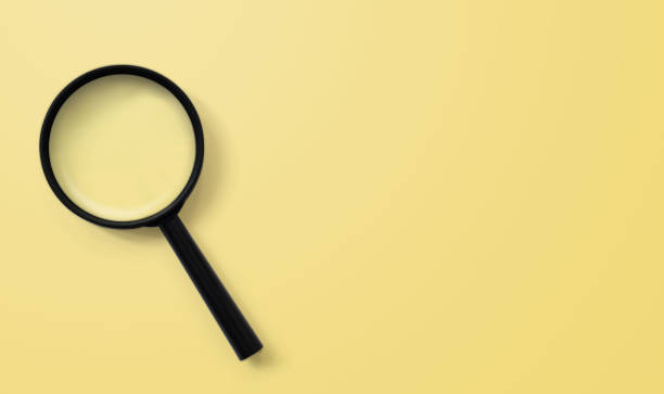 istock Magnifying glass on yellow colour background. Searching information data concept 1203966835