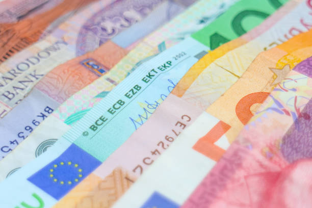 istock Rainbow of various international banknotes 1203967550