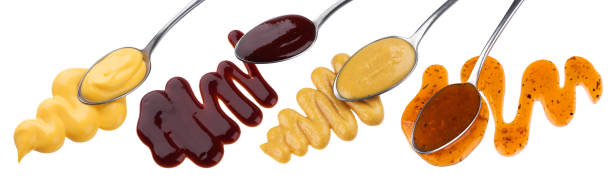 istock Set of various sauces in spoons isolated on white background 1203969599