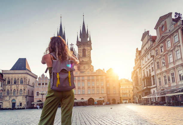Young woman taking photo from the Tyn Church in Prague stock photo