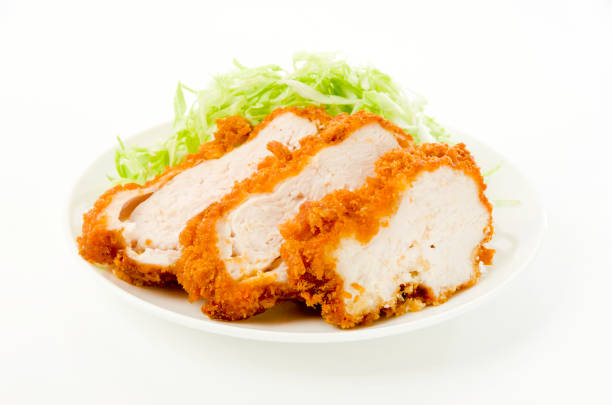 breaded chicken breast with Shredded Cabbage on a white dish on white background