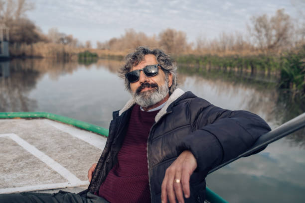 istock Mature man relaxing on his river boat 1203970456