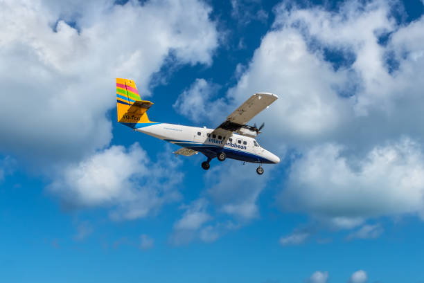 The InterCaribbean Airways De Havilland Canada DHC-6-300 Twin Otter airplane Simpson bay, Saint Maarten - December 17, 2018: The De Havilland Canada DHC-6-300 Twin Otter airplane landing at the Princess Juliana International Airport in Saint Martin, Dutch Antilles, Caribbean. de havilland dhc 6 twin otter stock pictures, royalty-free photos & images